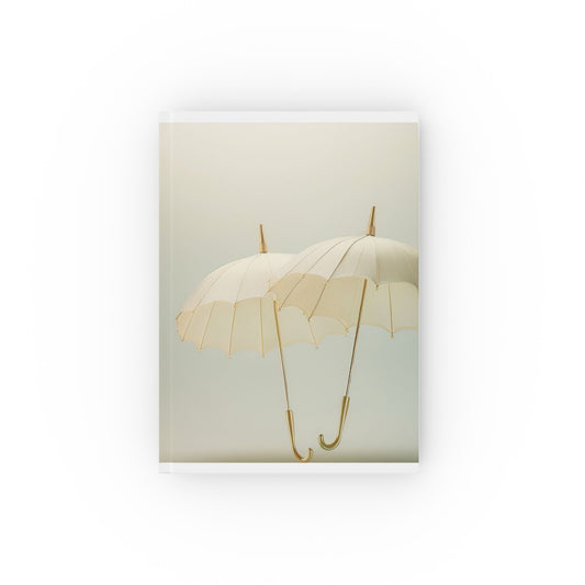 A5 hardcover journal with pale yellow cover and two floating umbrellas illustration