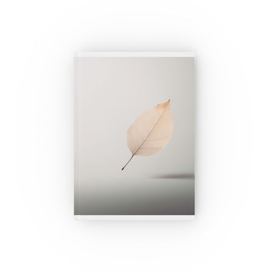 A5 hardcover journal with pale brown and greyscale cover and single floating leaf illustration