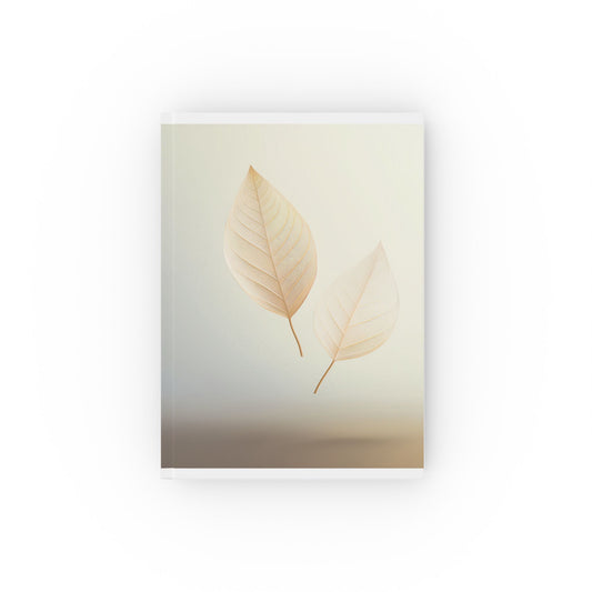 A5 hardcover journal with pale yellow cover and two floating leaves illustration