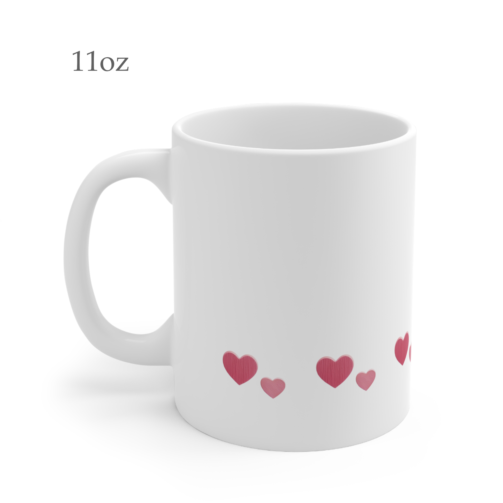 Left side view of white ceramic heart mug, 11oz size, showing handle. The heart design features two heart sizes in different shades of red, repeated in a row near the bottom.