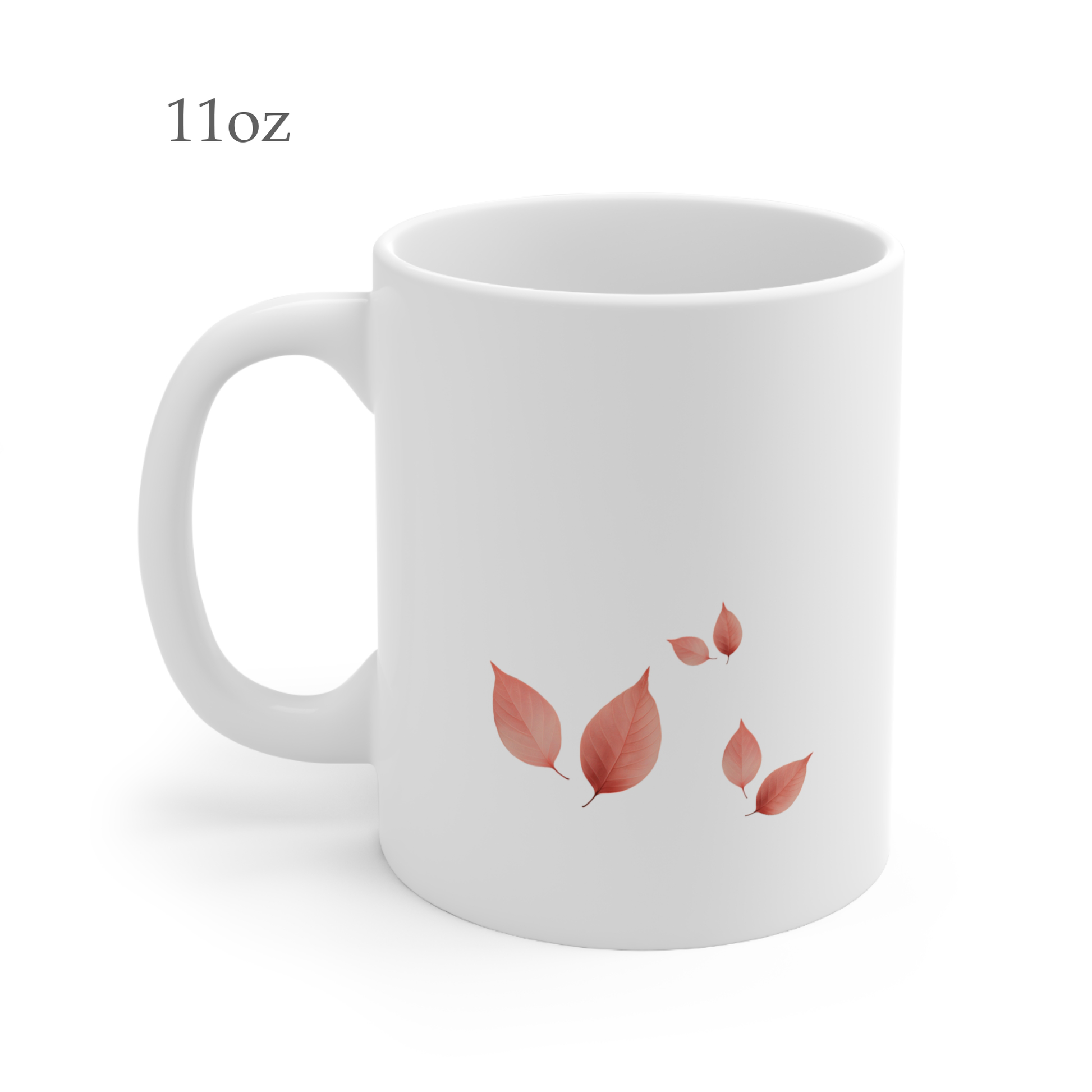 Left side view of white ceramic autumn leaf mug, 11oz size, showing leaf cluster and handle