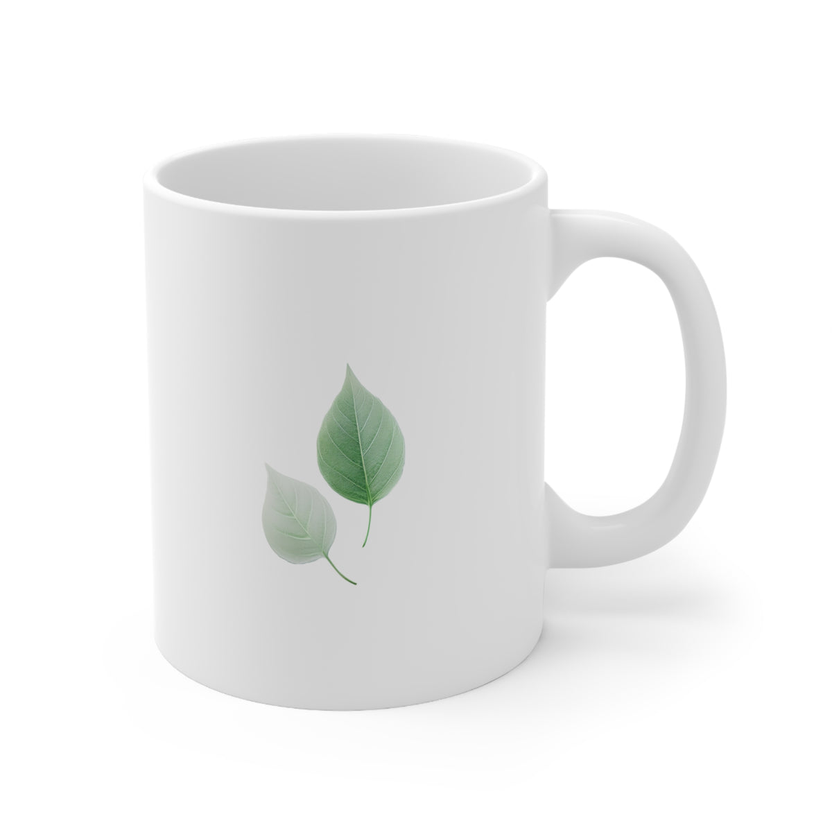 Right side view of white ceramic autumn leaf mug, 11oz size, showing two green leaves design and handle