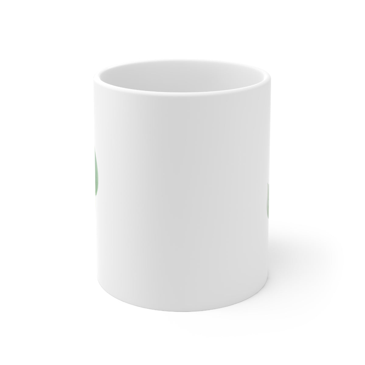 Front view of white ceramic mug with green and white autumn leaf design, 11oz size