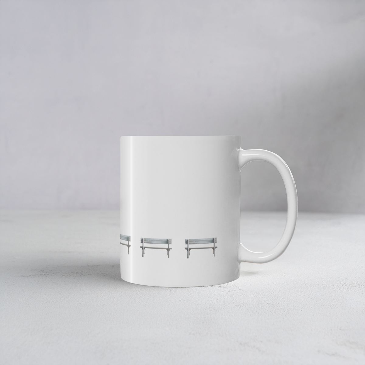 White ceramic mug with wooden bench design on a cement style surface