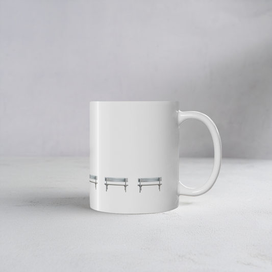 White ceramic mug with wooden bench design on a cement style surface