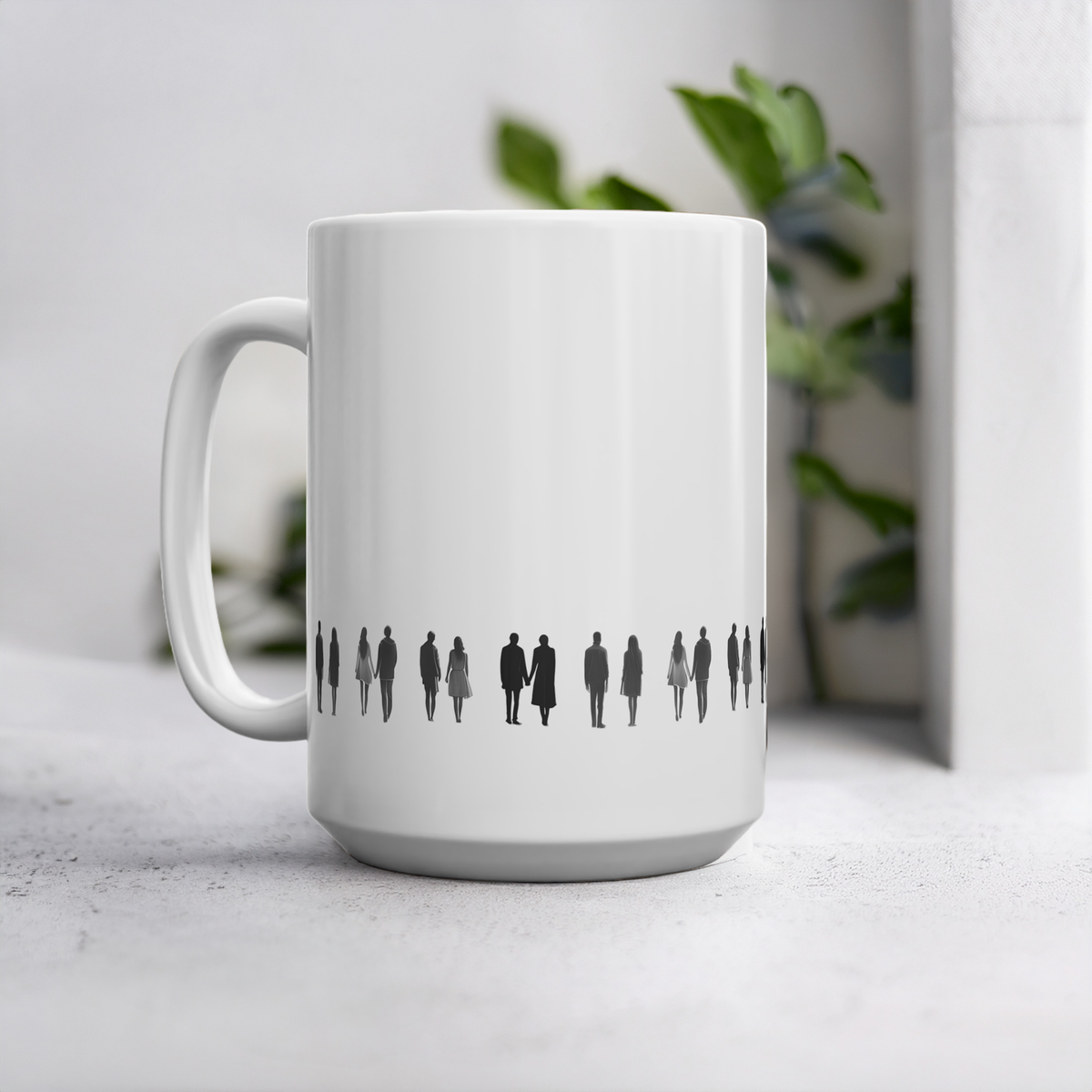 15oz white ceramic mug with black line art illustration of people holding hands, set against a softly blurred background with a plant.